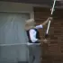 woman cleaning her gutters with GutterJet